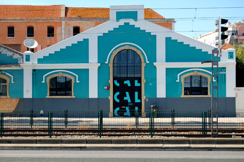 teal house near railway