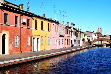 assorted-color painted houses beside body of water'