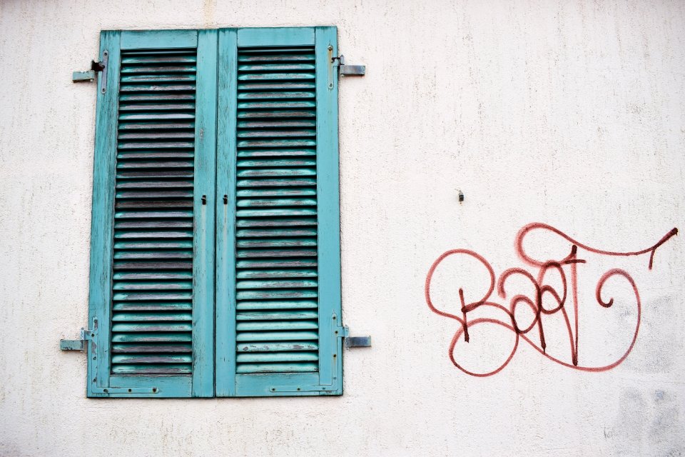 shut teal wooden window at daytime