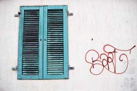 shut teal wooden window at daytime