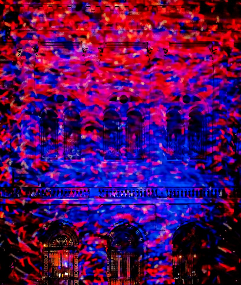 Red and blue spotlights vividly shining onto a building.