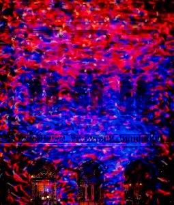 Red and blue spotlights vividly shining onto a building.