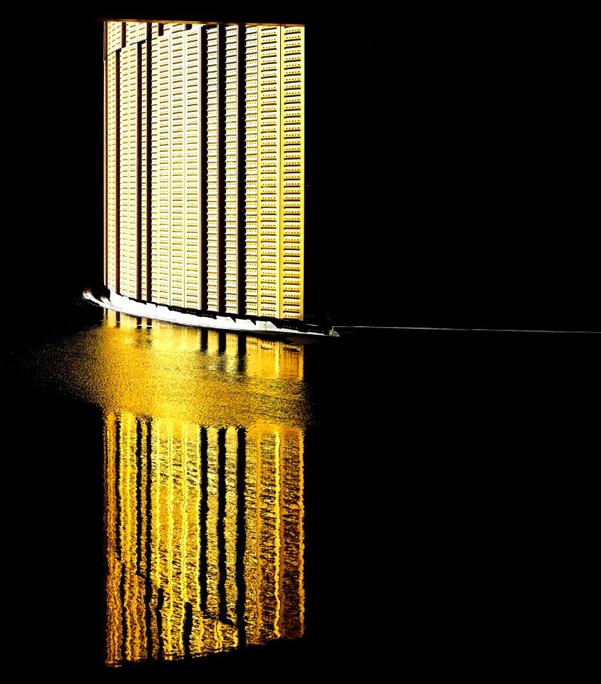The reflection of a brightly lit wall on the water surface at Fiera Milano Rho P5.