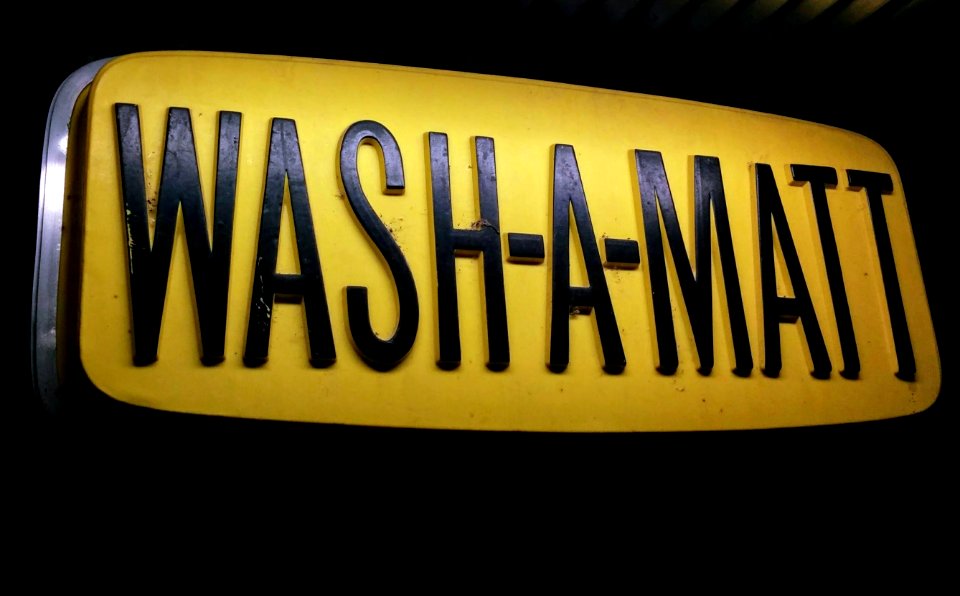 black and yellow Wash-A-Matt signage close-up photography