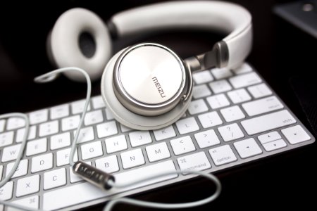 white Menzu corded headphones on Apple Magic keyboard photo
