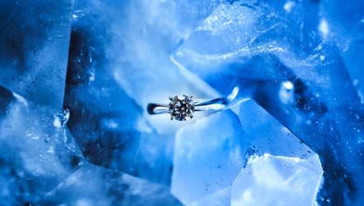silver-colored ring with clear gemstone inside ice photo