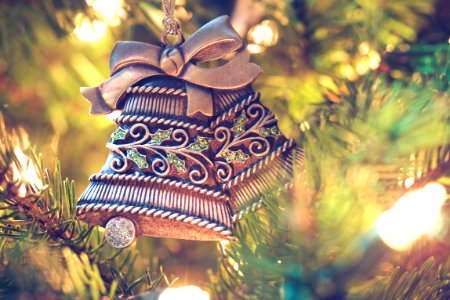 brown bell hanging on christmas tree