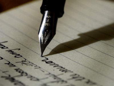 fountain pen on black lined paper photo