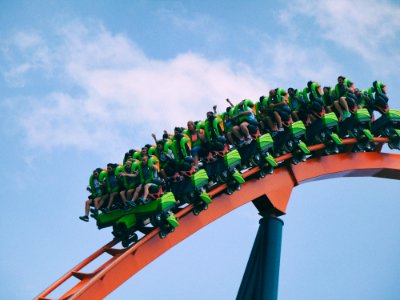 people riding on roller coaster photo