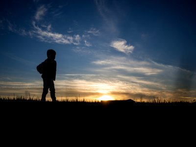 silhouette of person standing on grass field