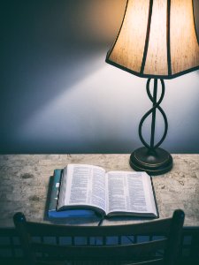 book beside the table lamp photo