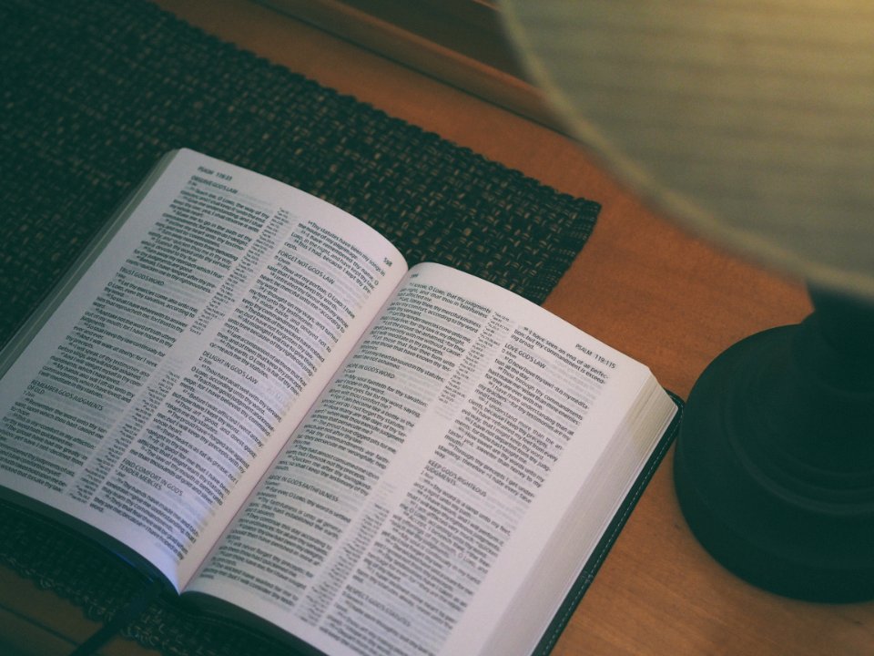 white book beside black table lamp