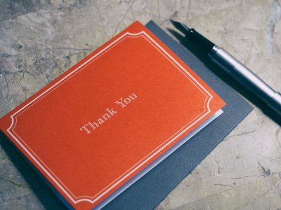 fountain pen next to red Thank You journal photo