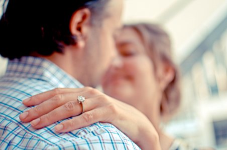 woman resting her hand on man's shoulder photo