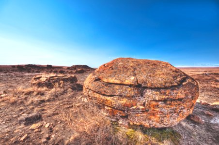 brown rock on deserted land under blue sky during daytime photo