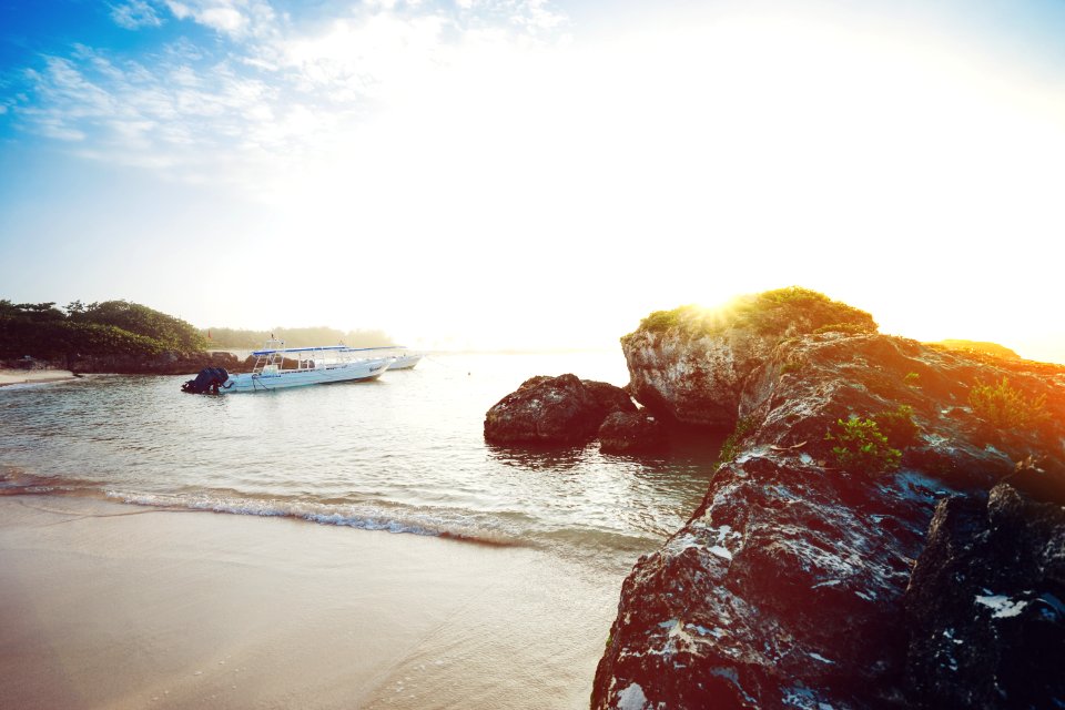 white boat near seashore during daytime