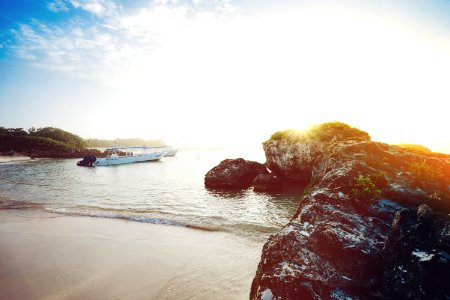 white boat near seashore during daytime