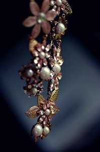 A piece of dangling pearl and flowers jewelry. photo