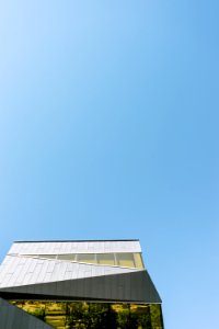 low-angle photography of white concrete building under clear blue sky photo