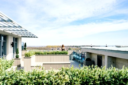woman on balcony during cloudy skies