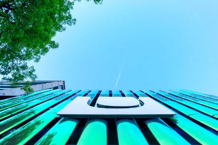 low angle photography of building under contrail photo