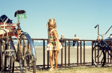girl standing near bicycle photo