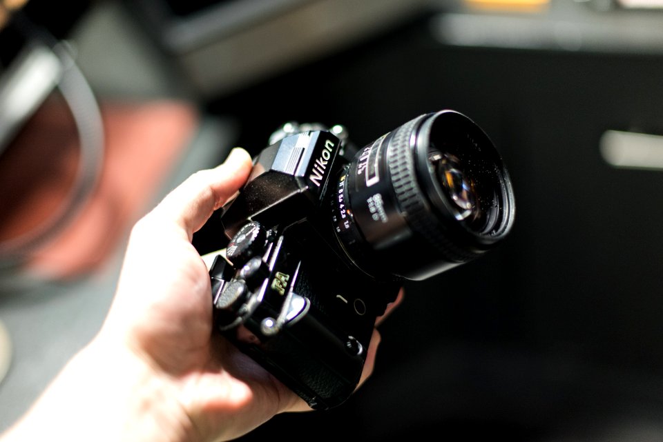 person holding Nikon camera