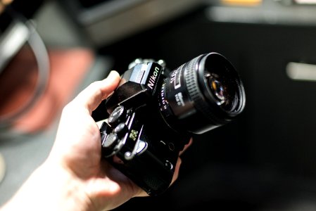 person holding Nikon camera