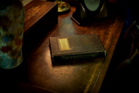Tennyson covered book on wooden surface near box