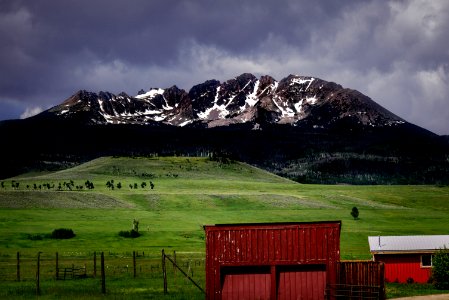 landscape photo of green grass field and mountain