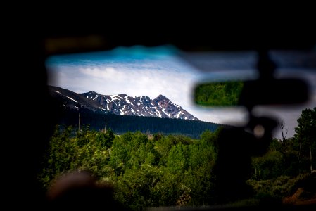 lowlight photography of rock formation beside forest photo