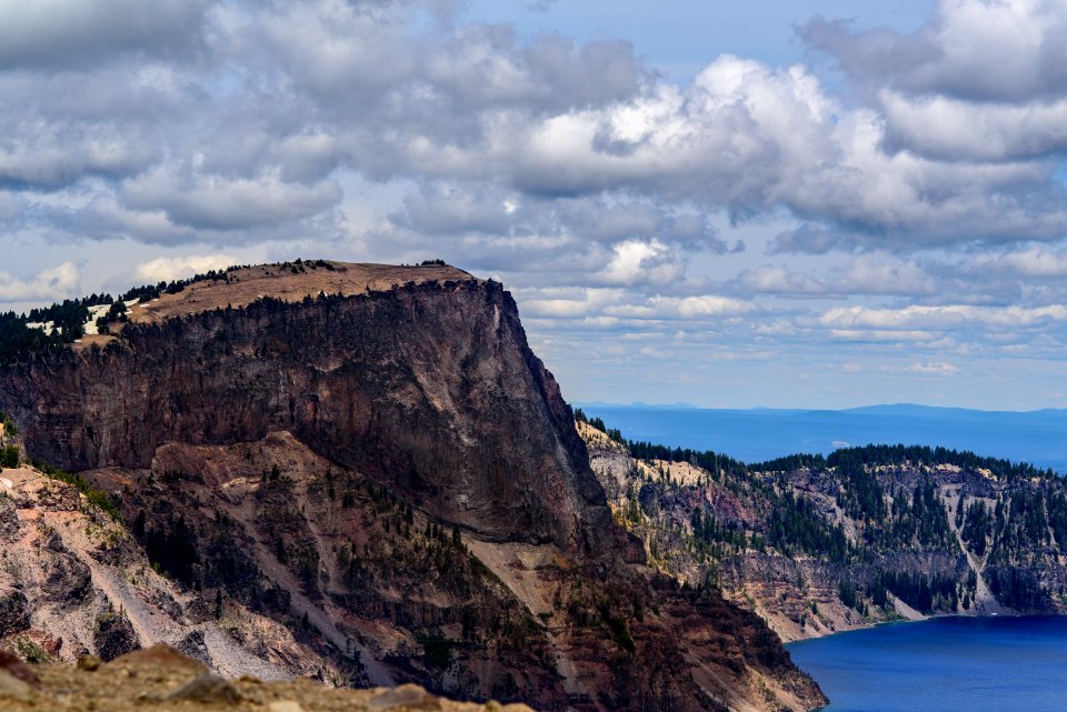aerial photo of mountain near body of water