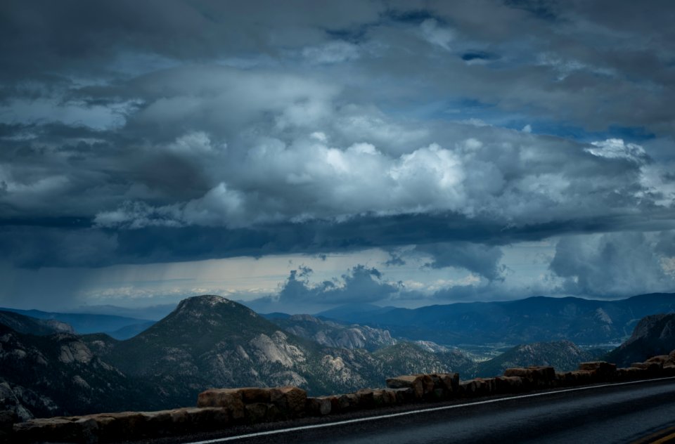 gray rocky mountains under cloudy sky during daytime