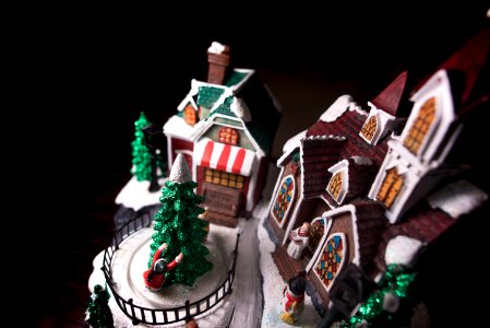 A model of the Christmas holiday replete with church, Christmas tree, snowman, house and people photo