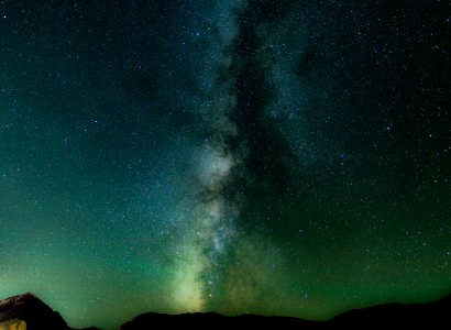 long exposure shot of stars over black mountains
