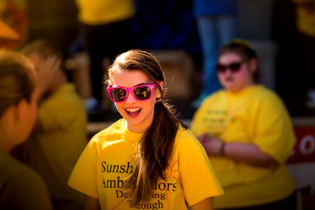 smiling girl wearing pink framed sunglasses photo