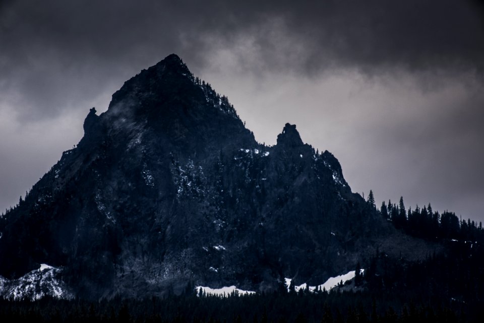 rocky mountain under dim sky