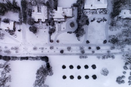 aerial photography of snow capped field near buildings photo