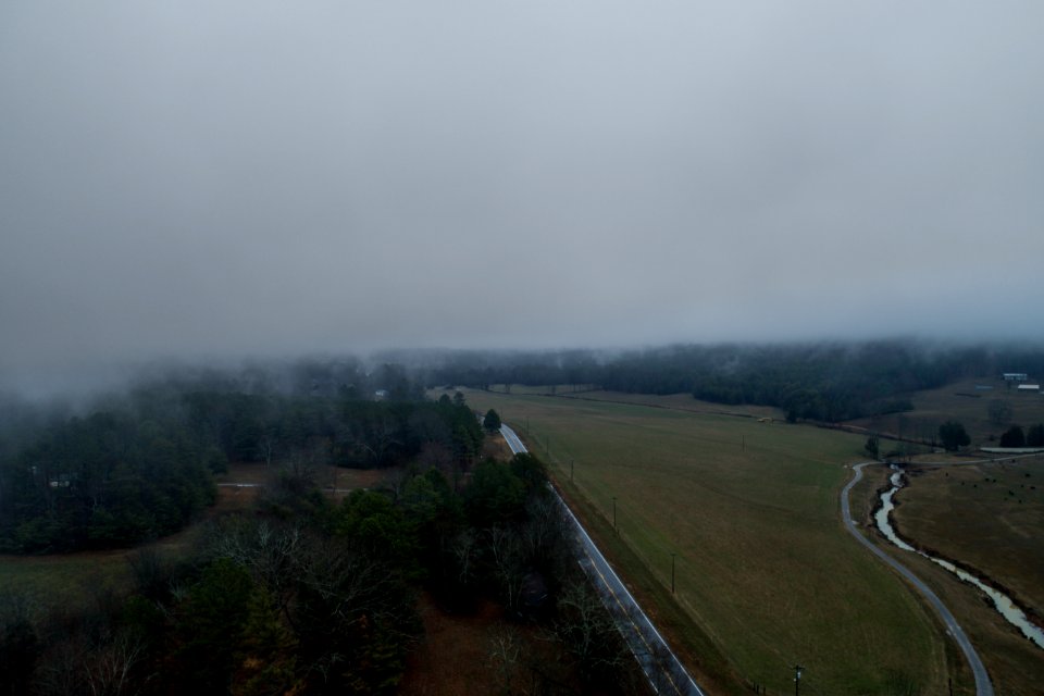 bird's eye view of road with thick fog during daytime
