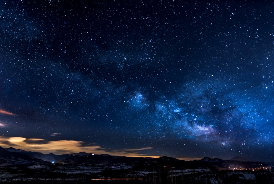 mountains with trees under white star at night