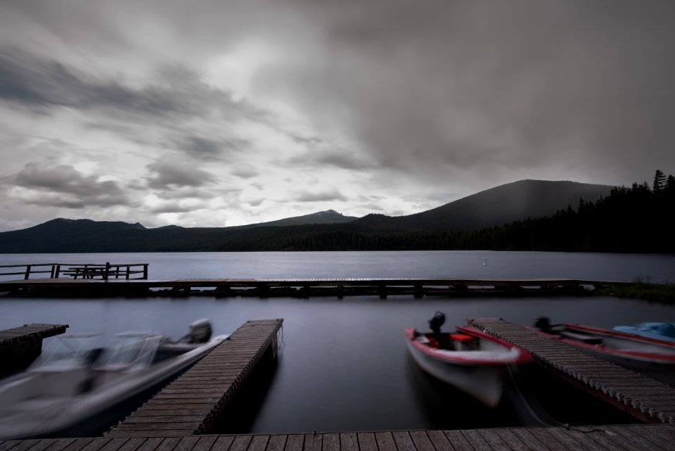 white boat near wooden dock over water