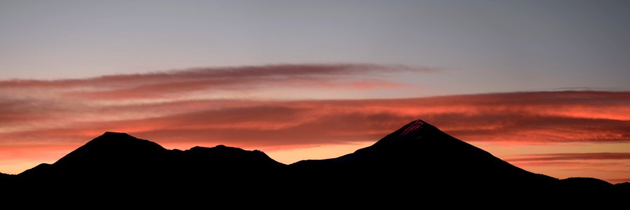 silhouette photo of mountains in sunset