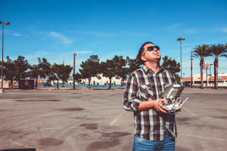 man standing while holding drone remote photo