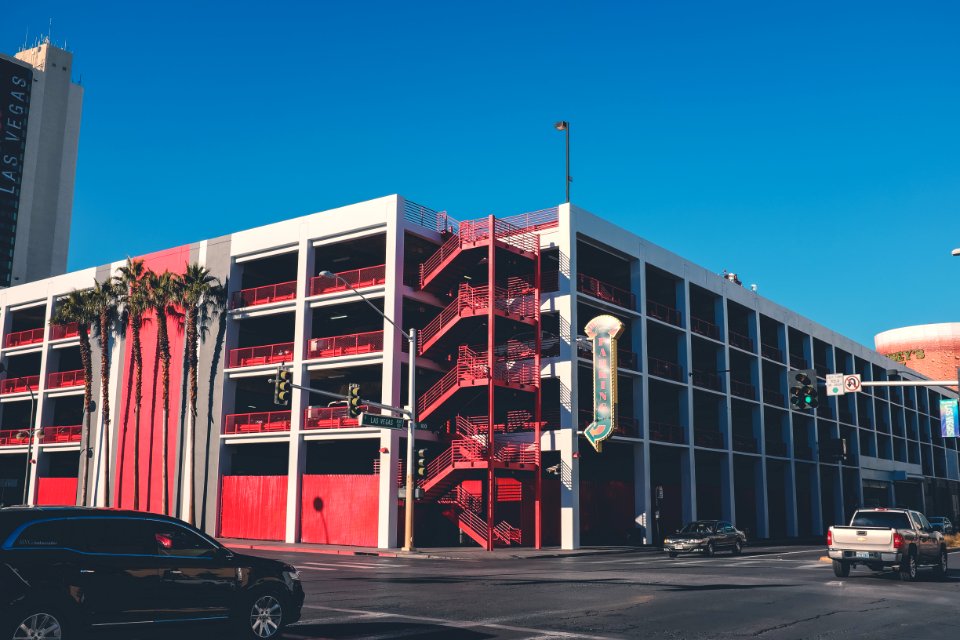 few vehicle near white and red building during daytime