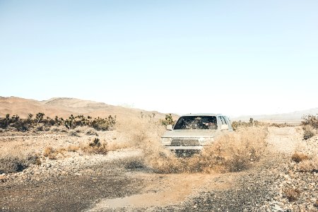 grey SUV on mud road photo