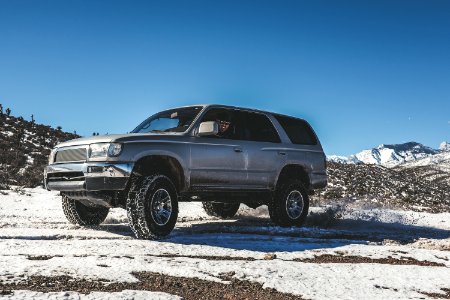 silver SUV on snow mountain photo