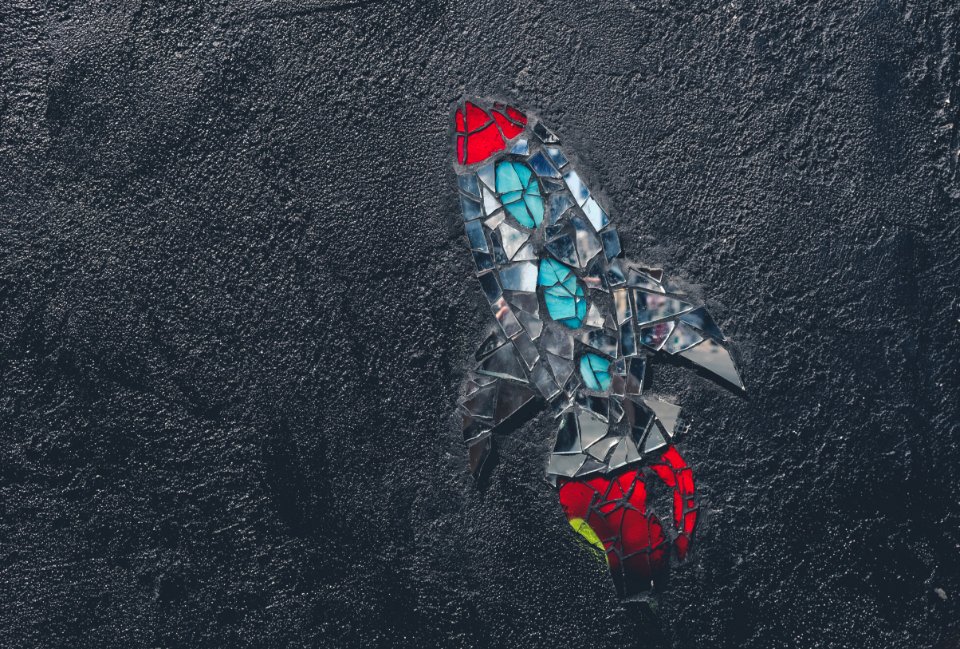 red, blue, and gray rocket stained glass