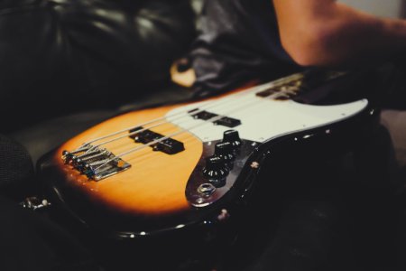 white and brown guitar close-up photography photo