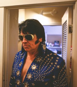 man wearing Elvis Presley costume at the doorway photo
