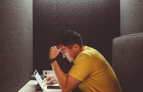 man using tablet computer on table photo